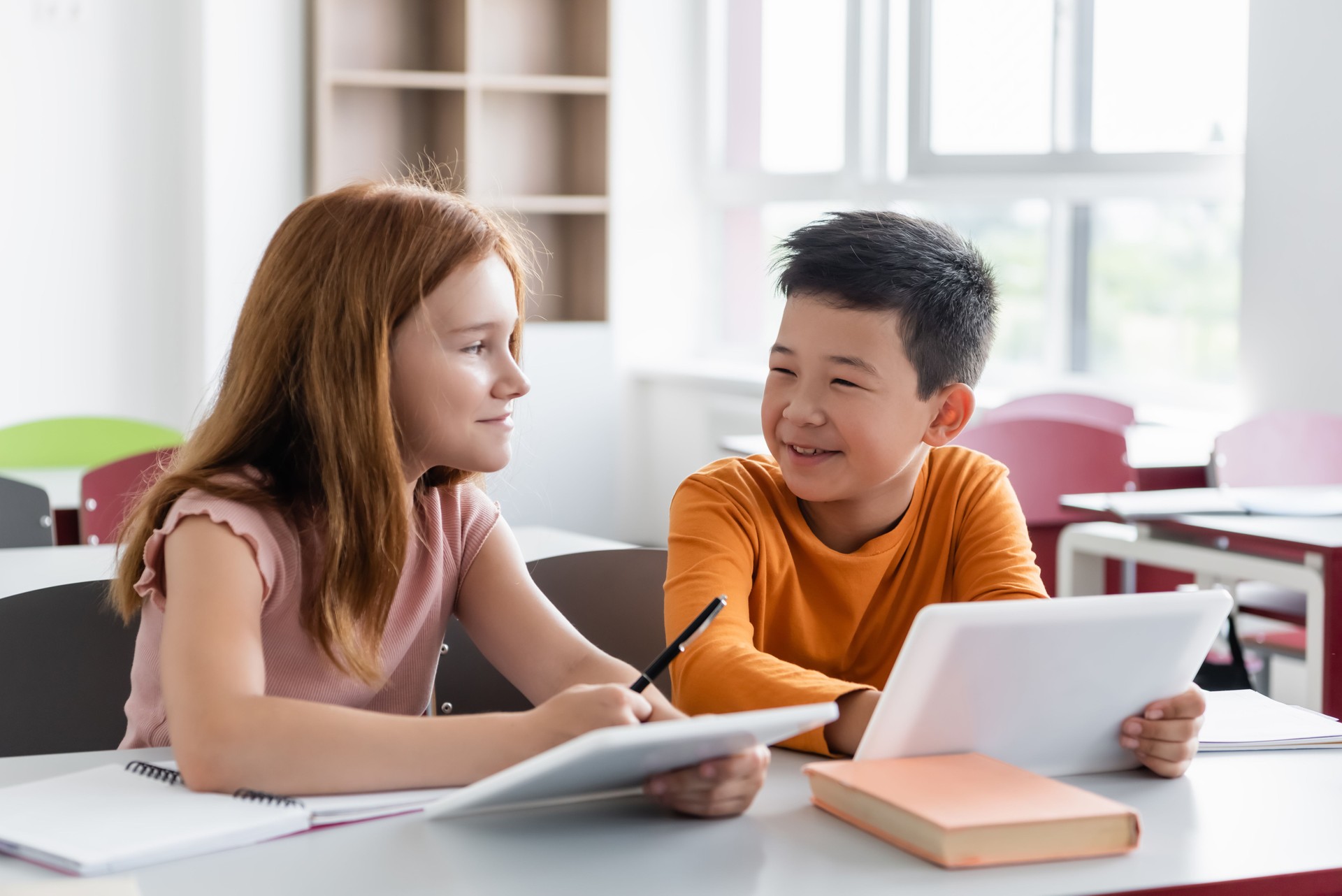 Multicultural students collaborate in a lively classroom session at a modern school