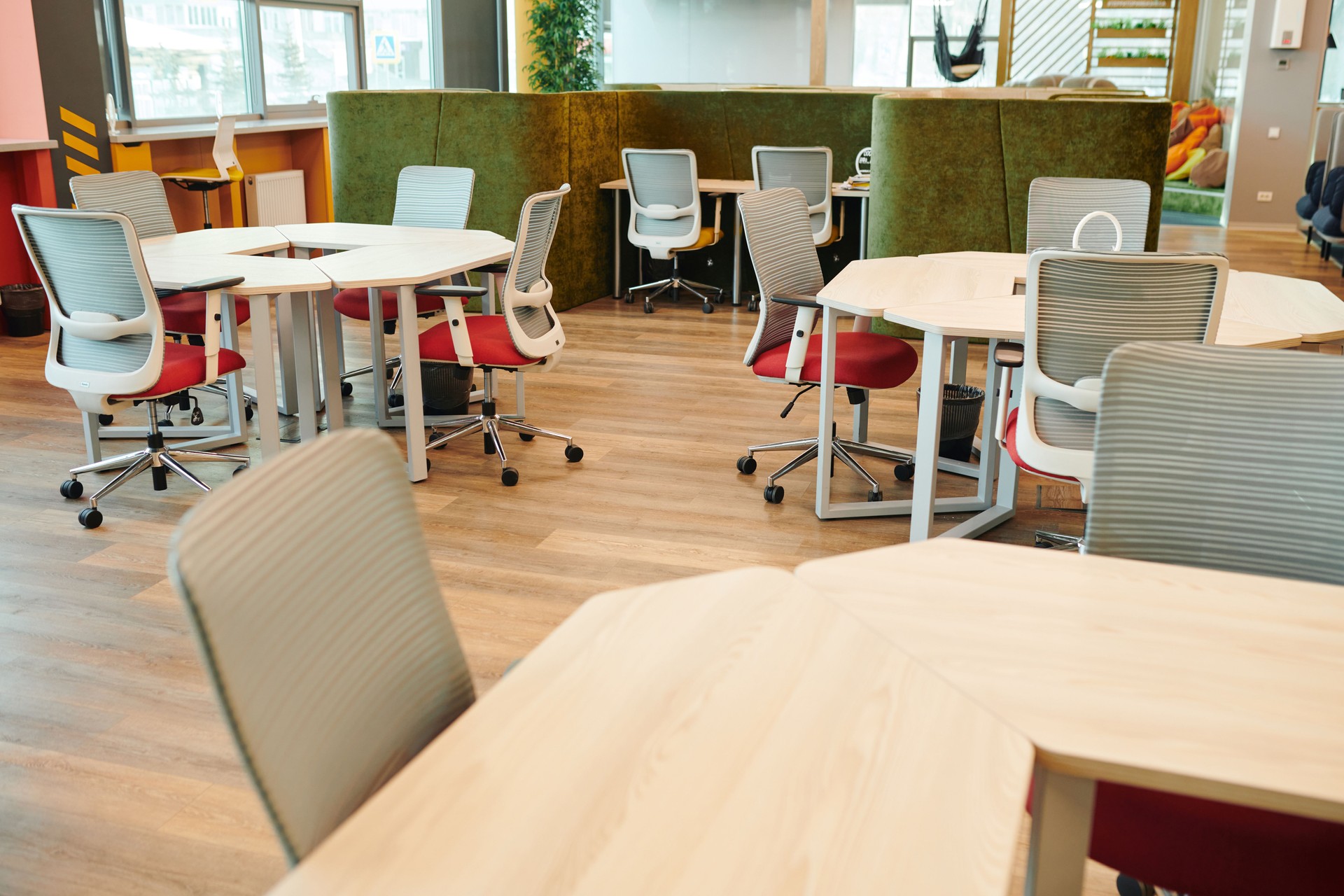 Interior of large open space office with many chairs by various kinds of tables